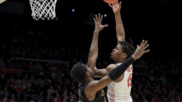 Nov 7, 2022; Dayton, Ohio, USA; Dayton Flyers forward DaRon Holmes II (15) dribbles the ball against Lindenwood Lions forward Remy Lemovou (42) in the first half at University of Dayton Arena. Mandatory Credit: Aaron Doster-USA TODAY Sports